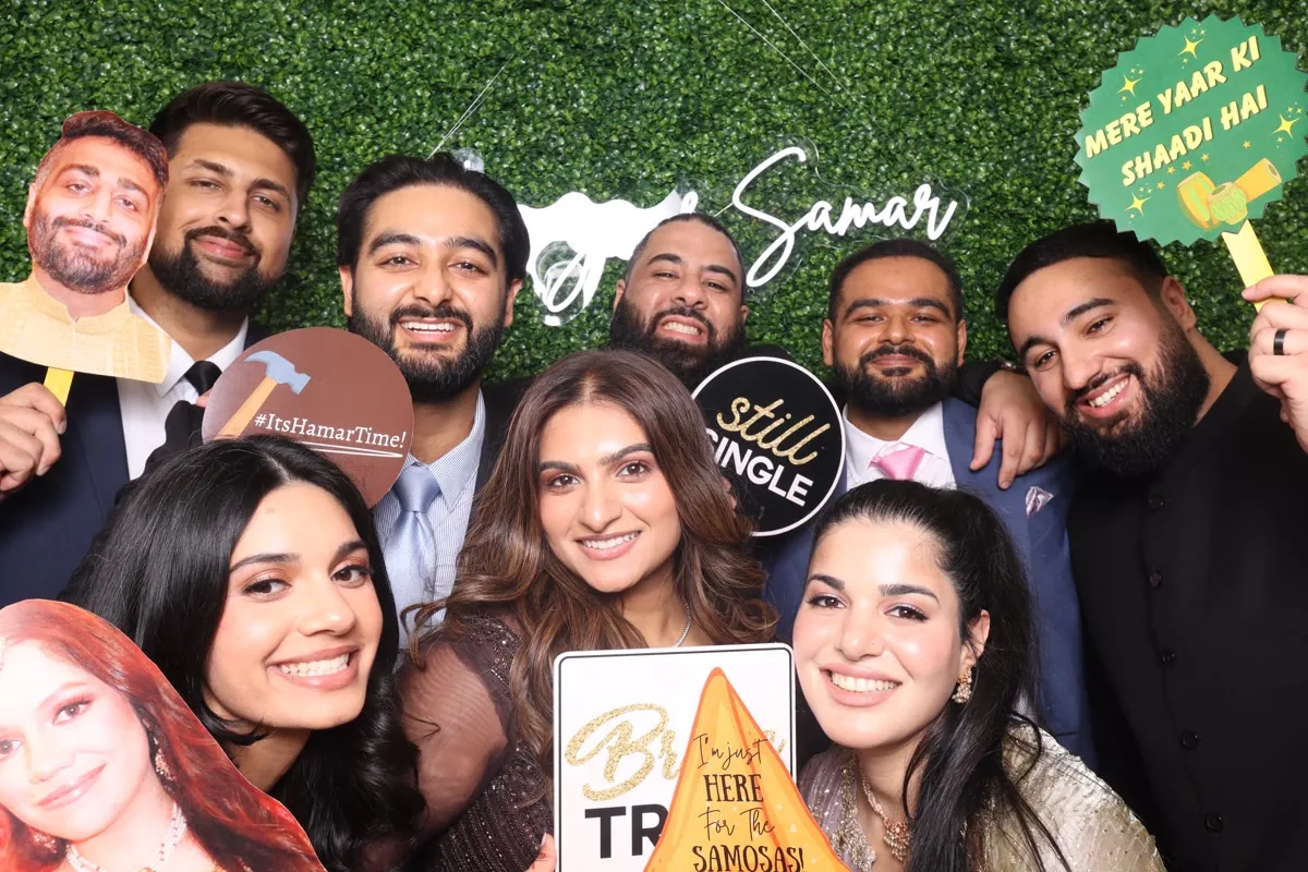 Clutch City luxury photo booth at Houston wedding with boxwood backdrop